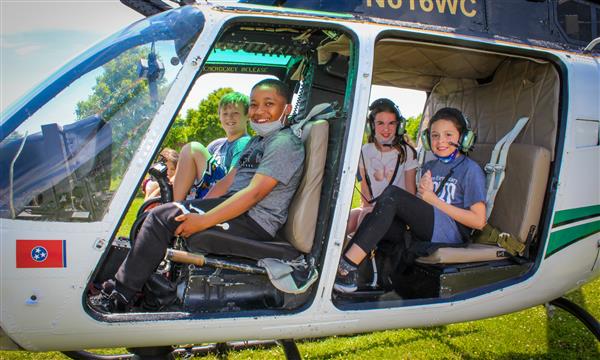 Students sit in helicopter